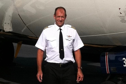 Pete Wilke poses in front of an airplane